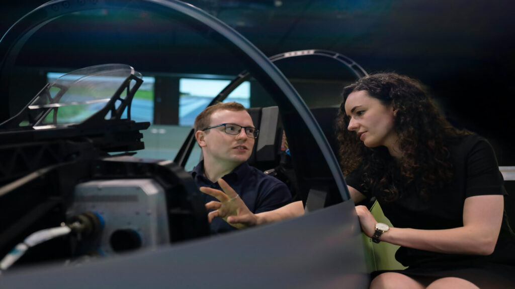 Engineers analyzing aircraft cockpit design during a simulation session