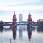 Cheapest Countries to Study Abroad: Beautiful reflection of Oberbaum Bridge on the River Spree at dusk in Berlin, Germany