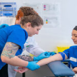 Best Medical Careers Without Becoming a Doctor-Nurses and a medical student practice blood draw in a clinical setting