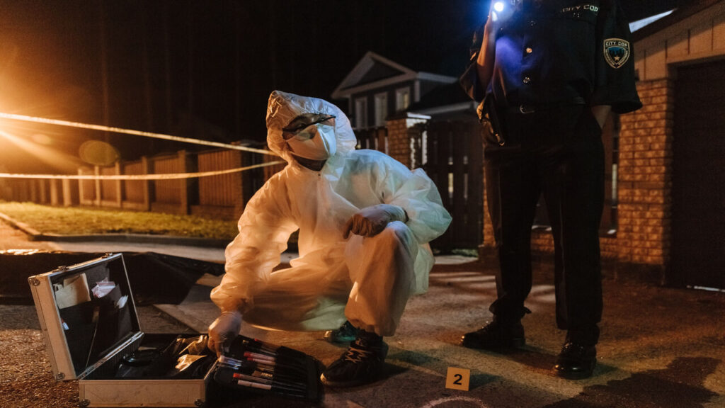 What Is Forensic Psychology-CSI team investigates a crime scene at night, using tools and flashlights for forensic analysis