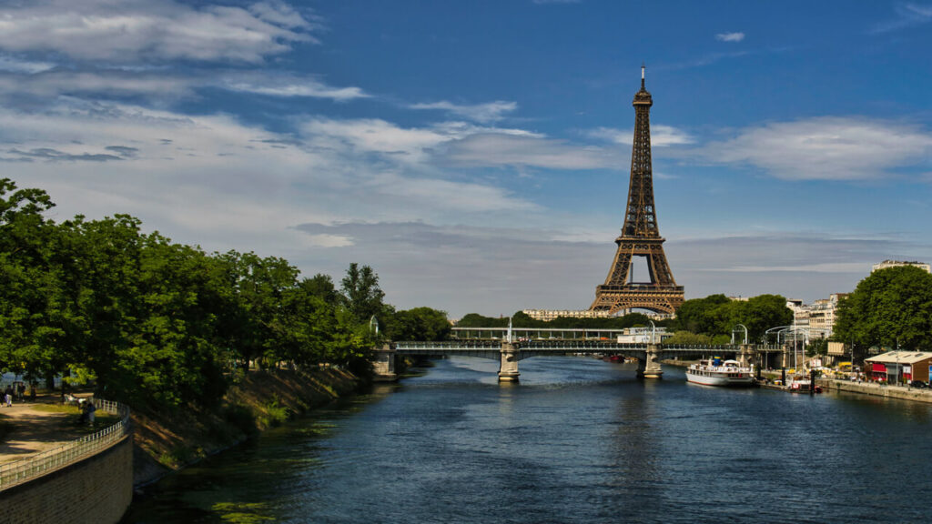 Scenic view of the Eiffel Tower and Seine River in Paris, captured on a sunny day