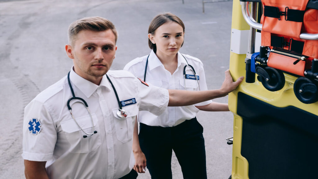 Two paramedics standing by an ambulance, showcasing readiness for emergency response