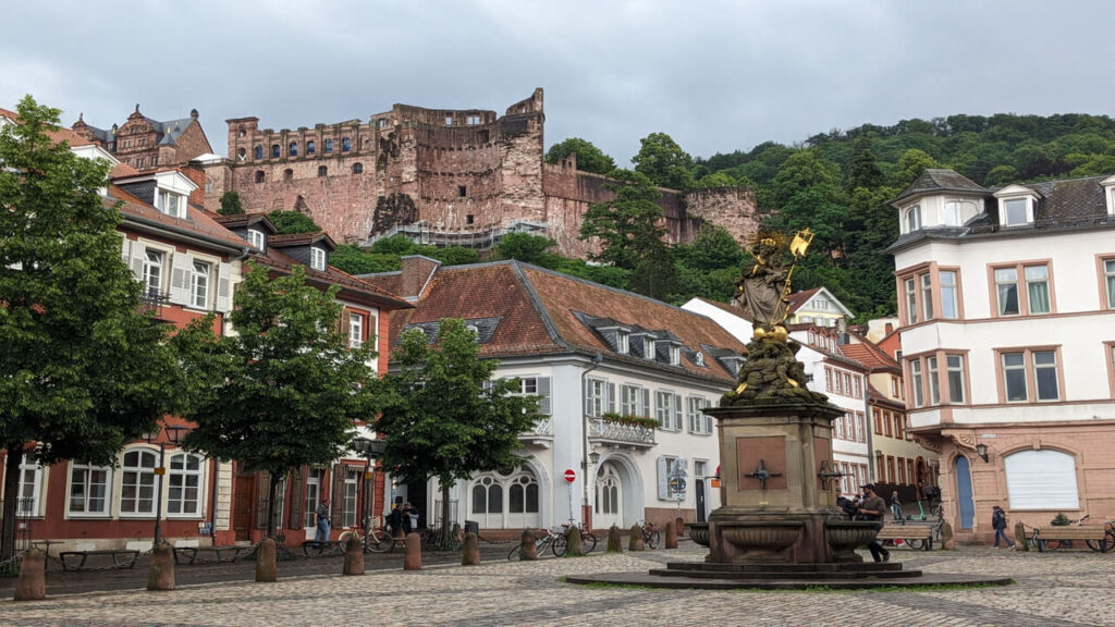 View of Heidelberg Castle overlooking a charming town square with classic architecture